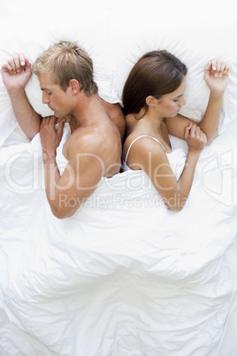 Couple lying in bed sleeping