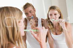 Couple in bathroom brushing teeth