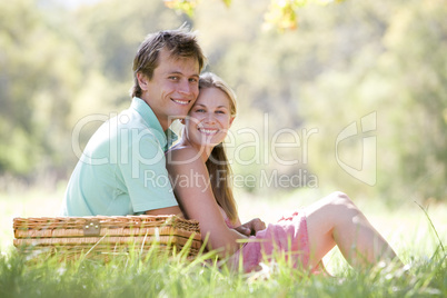 Couple at park having a picnic and smiling