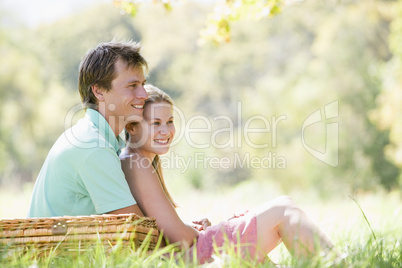 Couple at park having a picnic and smiling