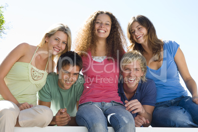 Five people on balcony smiling