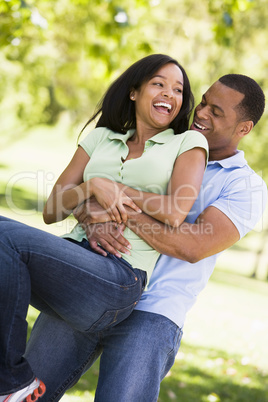 Couple being playful outdoors smiling