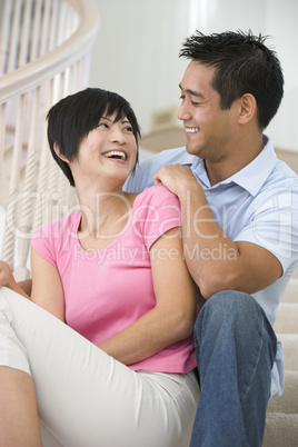 Couple sitting on staircase smiling