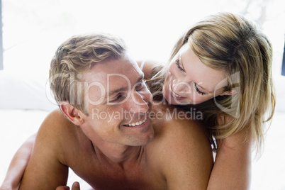 Couple lying in bed smiling