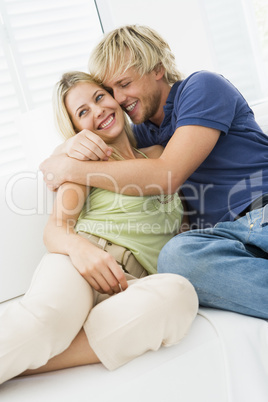 Couple in living room hugging and smiling