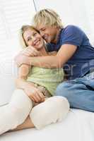 Couple in living room hugging and smiling