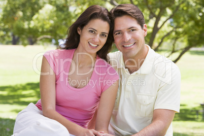 Couple sitting outdoors smiling