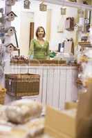 Woman in birdhouse store smiling