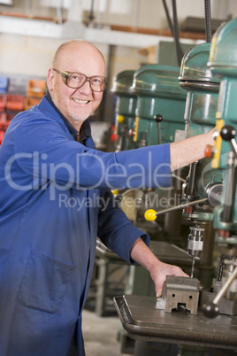 Machinist working on machine