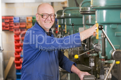 Machinist working on machine