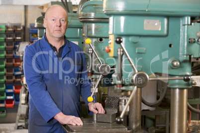 Machinist working on machine