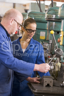 Two machinists working on machine