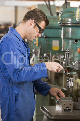 Machinist working on machine