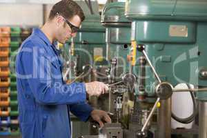 Machinist working on machine