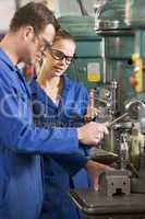 Two machinists working on machine