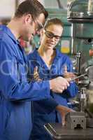 Two machinists working on machine