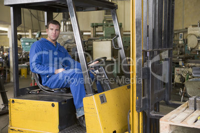 Warehouse worker in forklift