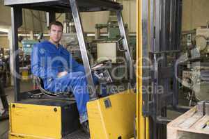 Warehouse worker in forklift