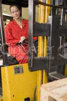 Warehouse worker in forklift