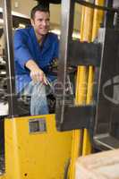 Warehouse worker in forklift