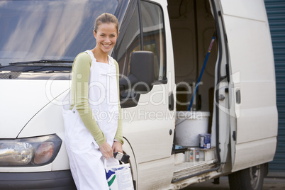 Painter standing with van smiling