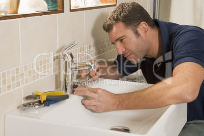 Plumber working on sink