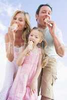 Family standing outdoors with ice cream