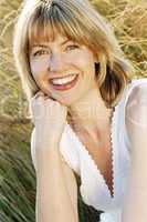 Woman sitting outdoors smiling