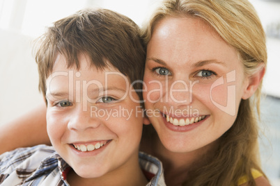 Woman and young boy in living room smiling