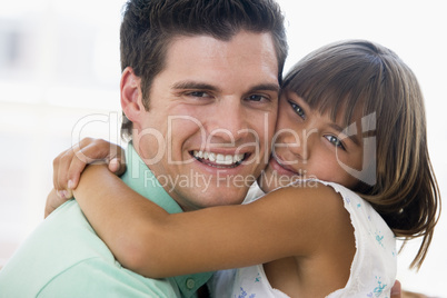 Man and young girl hugging and smiling