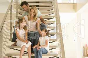 Family sitting on staircase smiling