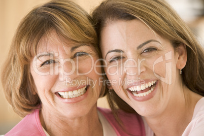 Two women in living room smiling