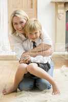 Woman in front hallway hugging young boy and smiling