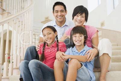 Family sitting on staircase smiling