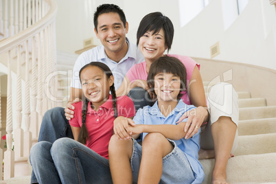 Family sitting on staircase smiling