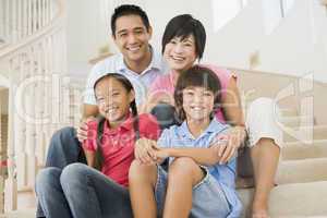 Family sitting on staircase smiling