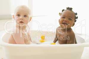 Two babies in bubble bath