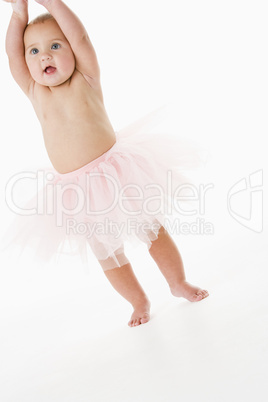 Baby standing in tutu