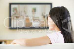 Young girl in living room with flat screen television