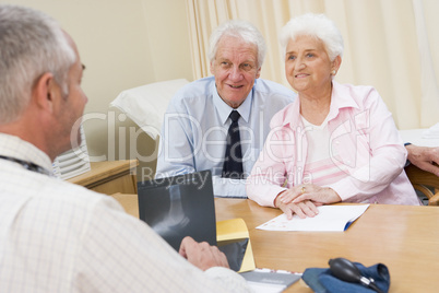 Couple in doctor's office smiling