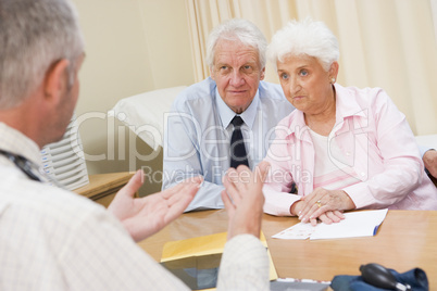 Couple in doctor's office frowning
