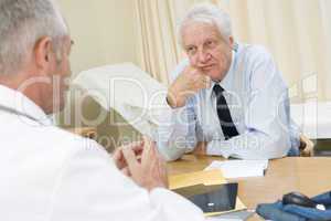 Man in doctor's office frowning