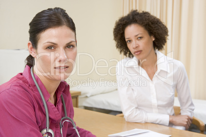 Woman in doctor's office frowning