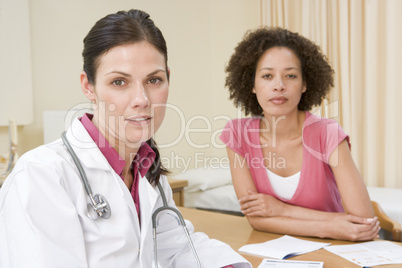 Woman in doctor's office frowning