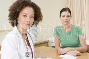 Woman in doctor's office frowning
