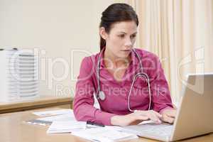 Doctor using laptop in doctor's office