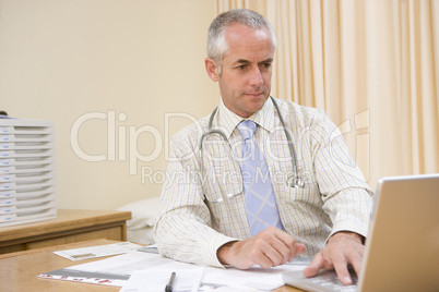 Doctor using laptop in doctor's office