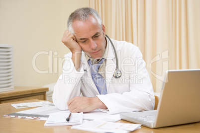 Doctor with laptop in doctor's office