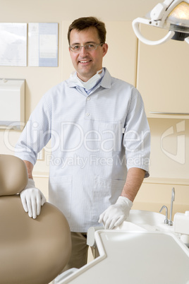 Dentist in exam room smiling