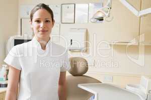 Dental assistant in exam room smiling